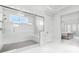 Spacious bathroom featuring a glass-enclosed shower with tile flooring and bench seating at 10254 Beechwood Ln, Orlando, FL 32832