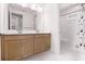 Bathroom with double sink vanity, large mirror, and shower/tub combo, offering plenty of space at 10254 Beechwood Ln, Orlando, FL 32832