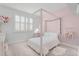 Cozy bedroom showcasing a four-poster bed frame and complemented by soft pink walls, creating a serene atmosphere at 10254 Beechwood Ln, Orlando, FL 32832