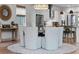 Bright dining area with stylish chandelier, white chairs and a view of the modern kitchen at 10254 Beechwood Ln, Orlando, FL 32832