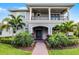 Two-story home with well-maintained landscaping, columned entrance, and wrought-iron balcony at 10254 Beechwood Ln, Orlando, FL 32832
