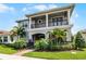 Stately two-story home with manicured lawn, lush landscaping, and covered front entrance at 10254 Beechwood Ln, Orlando, FL 32832