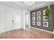 Bright foyer with wood floors, a decorative wall, and a modern light fixture at 10254 Beechwood Ln, Orlando, FL 32832