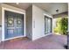 Charming front porch with double doors, brick pavers, and decorative wreaths creating an inviting entrance at 10254 Beechwood Ln, Orlando, FL 32832