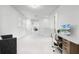 Spacious and bright hallway with white walls and carpet, showcasing a desk and additional seating at 10254 Beechwood Ln, Orlando, FL 32832