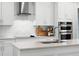 Close-up of modern kitchen features stainless steel appliances, quartz counters, and herringbone backsplash at 10254 Beechwood Ln, Orlando, FL 32832