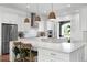 Bright, modern kitchen with white cabinets, stainless steel appliances, and double islands at 10254 Beechwood Ln, Orlando, FL 32832