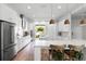 Spacious open kitchen with stainless appliances, a large island, and seating for casual dining at 10254 Beechwood Ln, Orlando, FL 32832