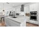 Contemporary kitchen boasting white cabinets, stainless appliances, and a spacious center island at 10254 Beechwood Ln, Orlando, FL 32832