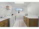 Well-organized laundry room with modern appliances, countertops, and ample storage space at 10254 Beechwood Ln, Orlando, FL 32832