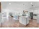 Open-concept living area with a modern kitchen, dining space, and cozy seating by the fireplace at 10254 Beechwood Ln, Orlando, FL 32832