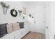 Bright mudroom features a bench with storage, accent pillows, and stylish wall decor at 10254 Beechwood Ln, Orlando, FL 32832