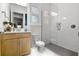 Bright bathroom with a glass-enclosed shower, wooden vanity, and modern fixtures, offering a clean and stylish design at 10254 Beechwood Ln, Orlando, FL 32832