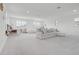 Spacious playroom features a white sectional, large windows and multiple shelving units at 10254 Beechwood Ln, Orlando, FL 32832