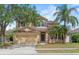 Charming two-story home featuring a well-maintained lawn, mature trees, and an attached two-car garage at 108 Portstewart Dr, Orlando, FL 32828