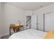 Bedroom with desk, closet, and neutral decor, creating a comfortable and organized space at 17407 Hidden Forest Dr, Clermont, FL 34714