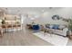 Open-concept living area featuring modern decor, a stylish kitchen, and a comfortable dining space at 17407 Hidden Forest Dr, Clermont, FL 34714