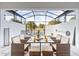 Covered patio area with dining table, ample seating and a peek of nature at 17407 Hidden Forest Dr, Clermont, FL 34714