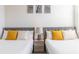 Bedroom with two twin beds featuring yellow and polka dot pillows at 17407 Hidden Forest Dr, Clermont, FL 34714