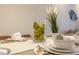 Dining area with a centerpiece consisting of artificial grass and fresh pears at 17407 Hidden Forest Dr, Clermont, FL 34714