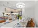 Dining area adjacent to a modern kitchen with stainless steel appliances and a large center island at 17407 Hidden Forest Dr, Clermont, FL 34714