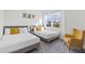 Bright bedroom with two twin beds, an armchair and ample natural light at 17407 Hidden Forest Dr, Clermont, FL 34714
