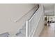 Bright staircase with modern white railing and gray carpet, leading to the upper level of the home at 17407 Hidden Forest Dr, Clermont, FL 34714