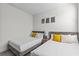 Bright bedroom with two twin beds featuring yellow and polka dot pillows at 17407 Hidden Forest Dr, Clermont, FL 34714
