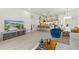 Bright living space featuring a modern kitchen, dining area, and entertainment setup with a large TV at 17407 Hidden Forest Dr, Clermont, FL 34714