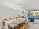 Inviting dining area with a stylish table set for a meal, open to living space at 17407 Hidden Forest Dr, Clermont, FL 34714