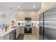 Modern kitchen with stainless steel appliances, sleek countertops, and ample cabinet space at 17407 Hidden Forest Dr, Clermont, FL 34714