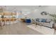 Open-concept living area featuring modern decor, a stylish kitchen, and a comfortable dining space at 17407 Hidden Forest Dr, Clermont, FL 34714
