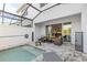 Inviting patio area with a refreshing pool, dining set, and comfortable seating, perfect for relaxation and entertaining at 17407 Hidden Forest Dr, Clermont, FL 34714
