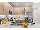 Bright kitchen featuring sleek countertops, stainless steel appliances, and modern wood cabinetry at 17407 Hidden Forest Dr, Clermont, FL 34714