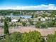 Aerial view of the community featuring lush green trees, a lake, and multiple residences at 200 Maitland Ave # 87, Altamonte Springs, FL 32701