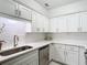 Modern kitchen with white cabinets, sleek countertops, and stainless steel appliances offer a clean, updated look at 200 Maitland Ave # 87, Altamonte Springs, FL 32701