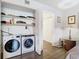 This laundry area features modern washer and dryer units, practical shelving and sleek flooring at 200 Maitland Ave # 87, Altamonte Springs, FL 32701