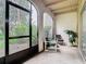 Enclosed patio space featuring a seating area, arched doorway, and views of the lush landscaping at 200 Maitland Ave # 87, Altamonte Springs, FL 32701