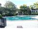 Outdoor community pool surrounded by lush greenery and lounge chairs for residents at 200 Maitland Ave # 87, Altamonte Springs, FL 32701