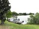 View of the lake with multiple boats docked on the grassy shoreline of this property's waterfront at 200 Maitland Ave # 87, Altamonte Springs, FL 32701