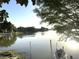 Waterfront view with a glimpse of a boat in the foreground and neighborhood homes in the background at 200 Maitland Ave # 87, Altamonte Springs, FL 32701