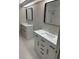 Bright bathroom featuring double sink vanity with modern black hardware and neutral tiling at 2832 Risser Ave, Orlando, FL 32812