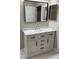 Bathroom with a white vanity, marble countertop, black hardware, modern mirror, and a door leading to another room at 2832 Risser Ave, Orlando, FL 32812