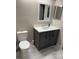 Bathroom with gray vanity, toilet, and neutral tile flooring at 2832 Risser Ave, Orlando, FL 32812