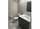 Bathroom with gray vanity, toilet, and neutral tile flooring at 2832 Risser Ave, Orlando, FL 32812