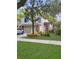 Charming two-story home features a well-manicured lawn, mature trees, and attached two-car garage at 2832 Risser Ave, Orlando, FL 32812