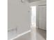 The bright hallway features white tile floors and white closets at 2832 Risser Ave, Orlando, FL 32812