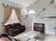 A spacious living room boasts a dramatic staircase, large windows, and stylish decor at 2832 Risser Ave, Orlando, FL 32812