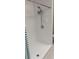 White tiled shower with new shower head and fixtures at 2832 Risser Ave, Orlando, FL 32812