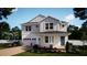 Charming two-story home with a blue front door, well-manicured lawn, and inviting curb appeal at 331 Ridgemark Ave, Groveland, FL 34736